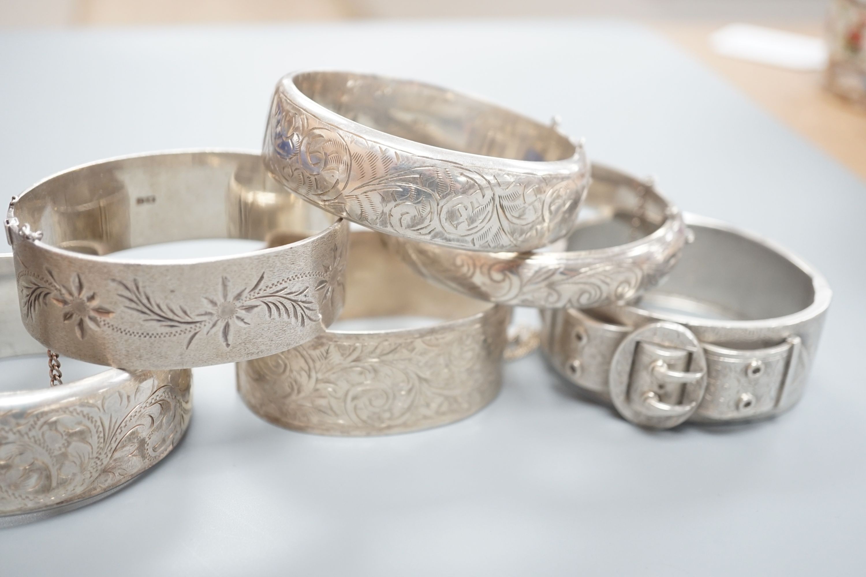 A Victorian silver bangle, Birmingham, 1885 and five later silver bangles.